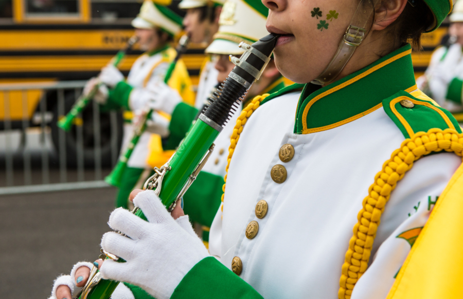 A young boy playing a flute marches in theannual St. Patrick's Day parade