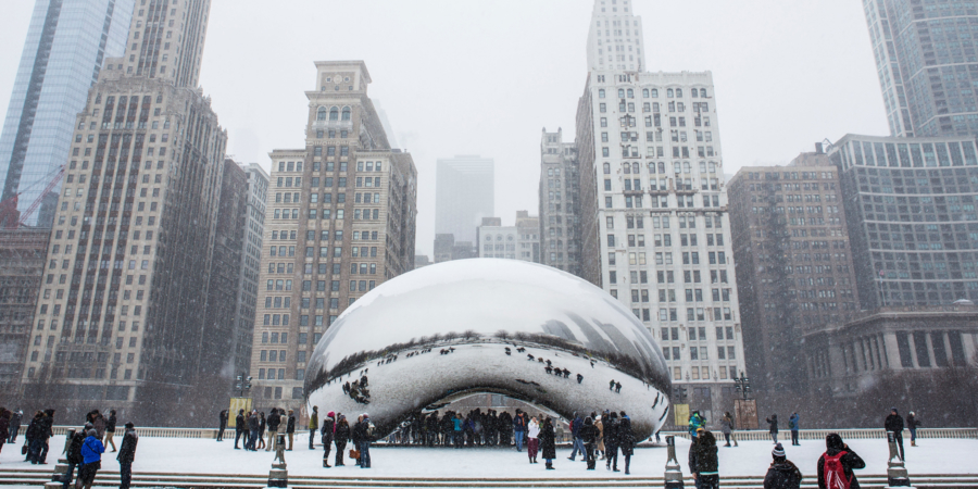 People around Chicago’s Cloud Gate, The Bean, in the snow