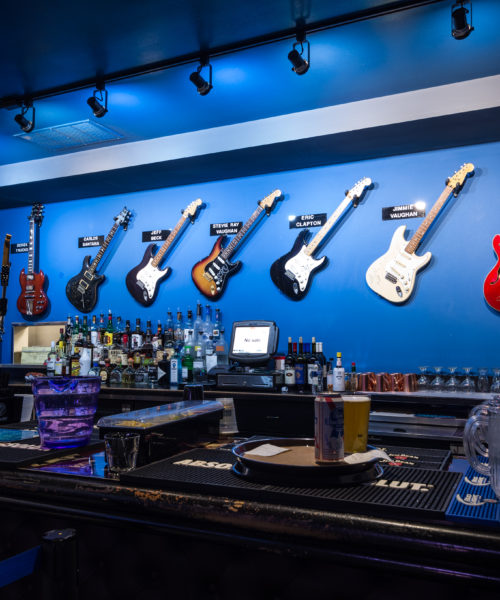 Guitars hang on a wall behind the bar at Buddy Guy's Legends