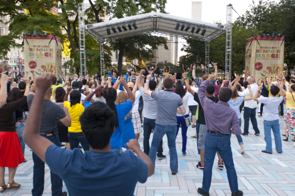 Crowd of people fist pumping at the Chicago Summer Dance