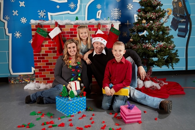 Photo of a family in front of a fake fireplace for Holiday Bricktacular
