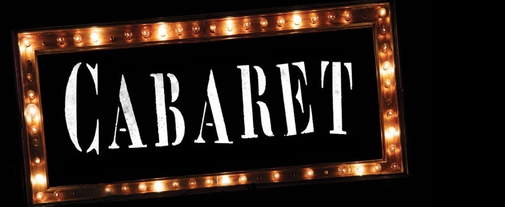 Sign with lights around it that says Cabaret