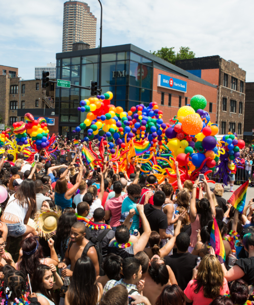 Parade marchers wil rainbow balloons at the Chicago Pride Parade
