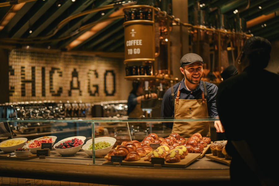  Man behind the food counter talking to a customer in the Starbucks Reserve Roastery in Chicago