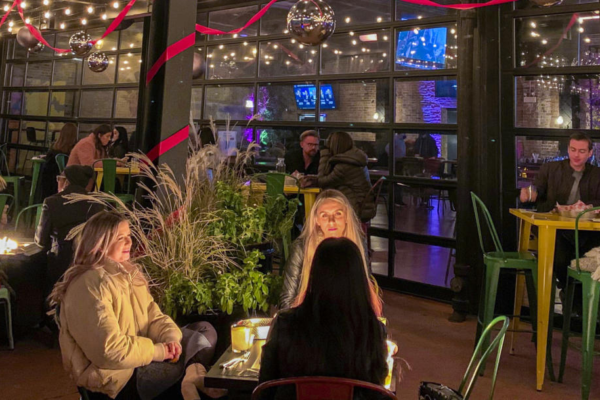 friends gather on the patio of Recess bar