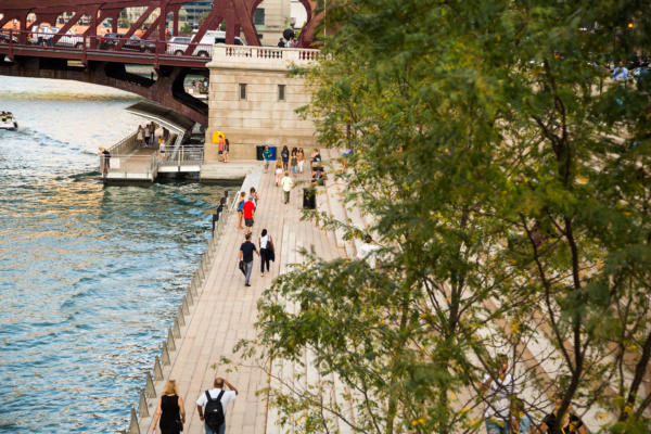Pedestrians walk on the Chicago Riverwalk in summer