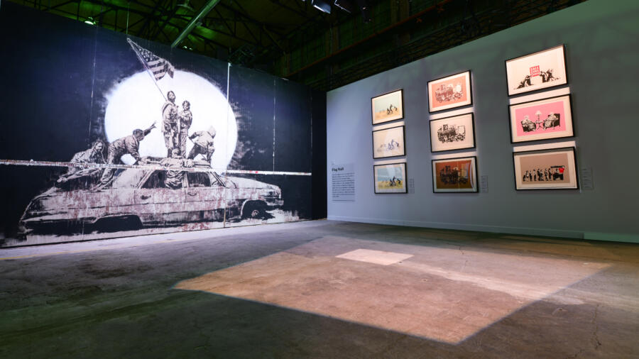 Image of the Flag Wall room at The Art of Banksy exhibition in Toronto. Courtesy of The Art of Banksy.