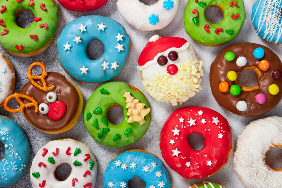 Set of Christmas donuts on gray stone background. Christmas and New Year celebration concept. Top view.