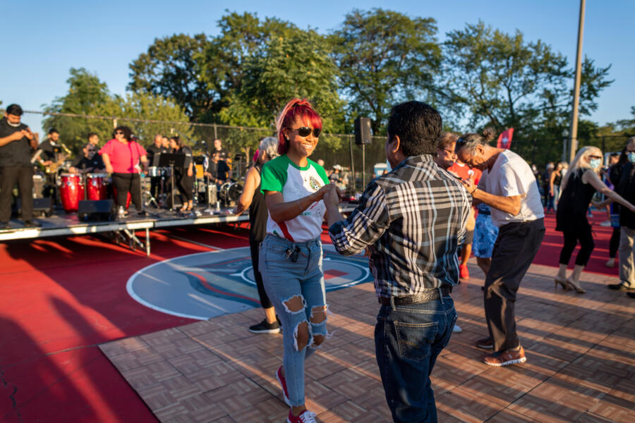 People dance at the SummerDance in the Parks series at Portage Park in Chicago's Portage Park neighborhood.