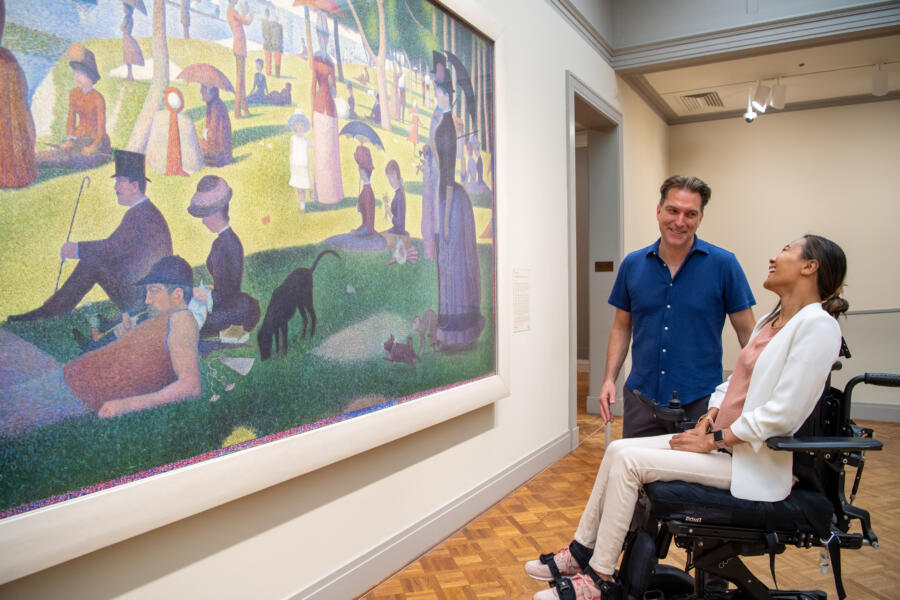 Two guests admire A Sunday on La Grande Jatte at the Art Institute of Chicago