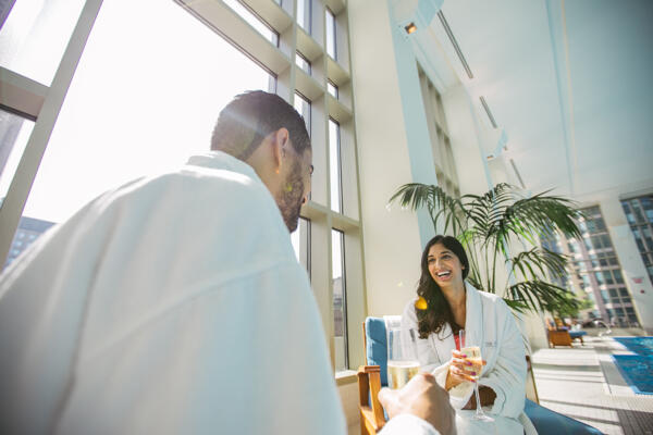 Couple wearing white robes in The Peninsula Chicago's Spa & Wellness Center