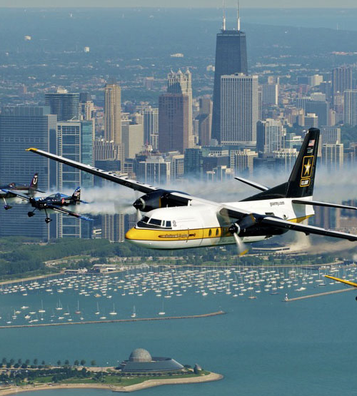 Multiple planes fly over the Chicago city skyline during the Air and Water Show.