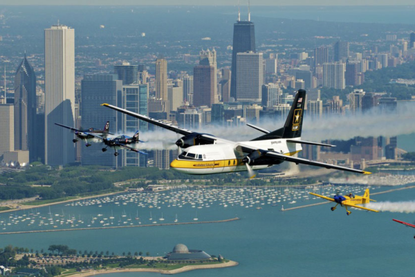 Multiple planes fly over the Chicago city skyline during the Air and Water Show.
