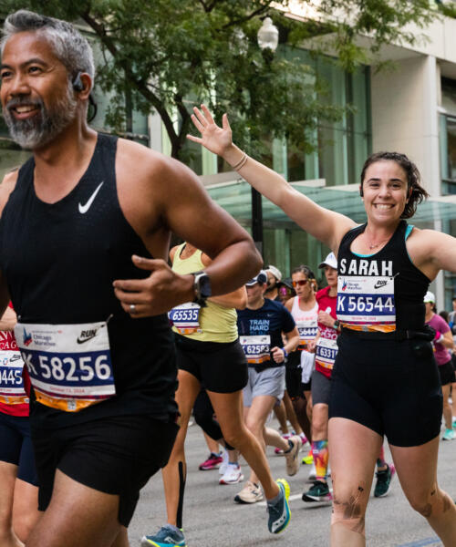 A large group of joggers run through the Chicago streets during the Chicago Marathon.