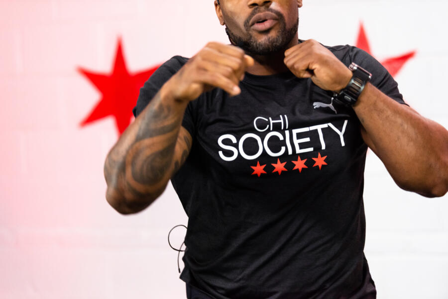 A fitness instructor with a CHI SOCIETY shirt
