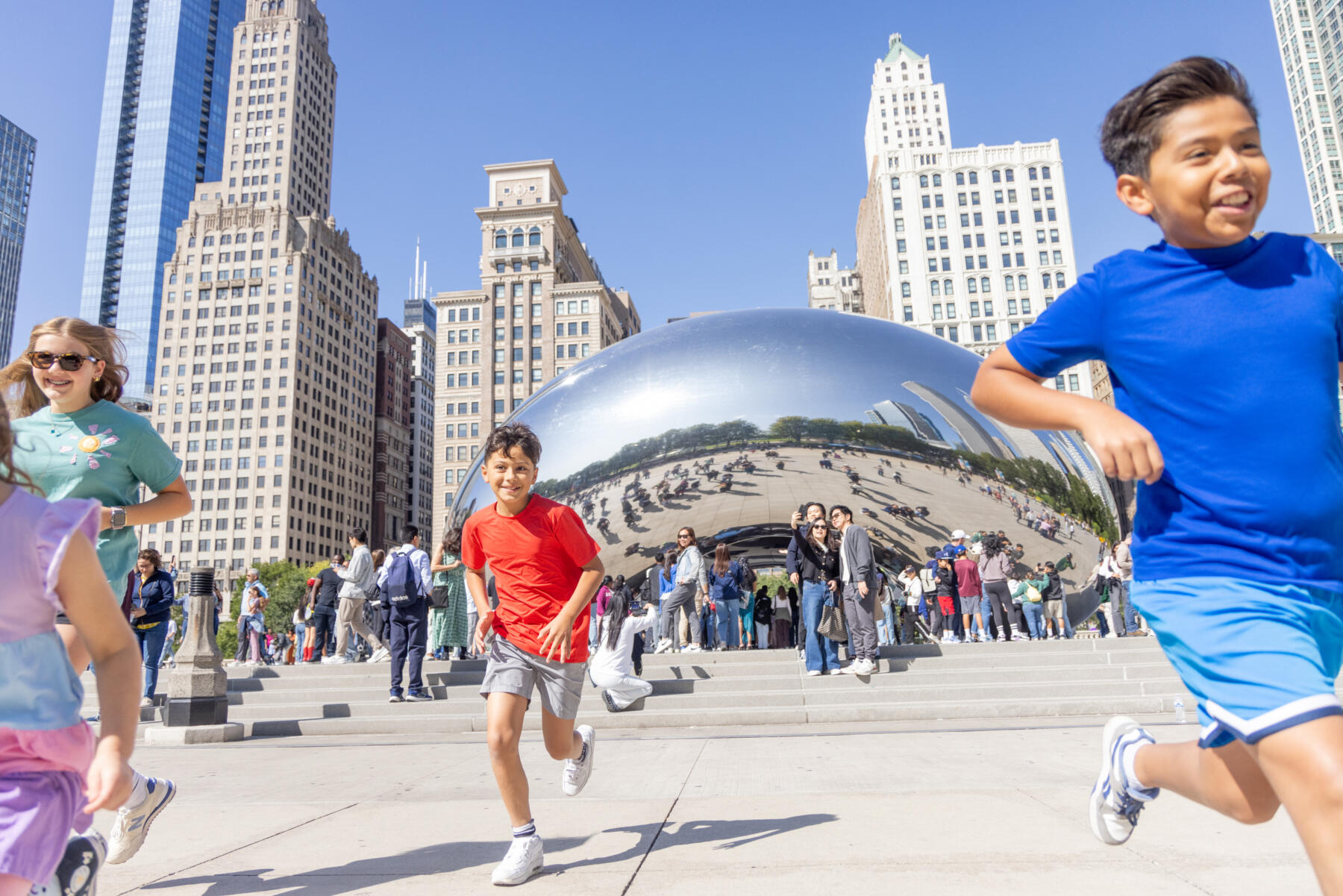 Kids playing by The Bean in Millennium Park