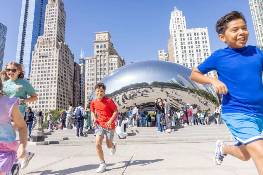 Kids playing by The Bean in Millennium Park