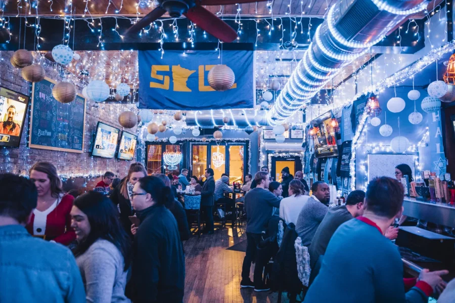Bar patrons enjoying the festive holiday lights at 8 Crazy Nights in Chicago.