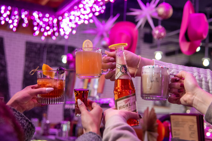 Customers cheers with various drinks and cocktails at the Big Star Wrigleyville holiday pop-up bar