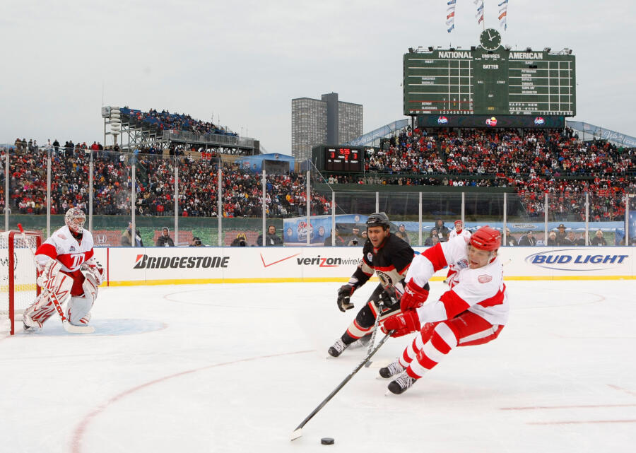 CHICAGO - JANUARY 01: Brad Stuart #23 of the Detroit Red Wings controls the puck as Dustin Byfuglien #33 of the Chicago Blackhawks follows during the NHL Winter Classic at Wrigley Field on January 1, 2009 in Chicago, Illinois. (Photo by Dave Sandford/NHLI via Getty Images)