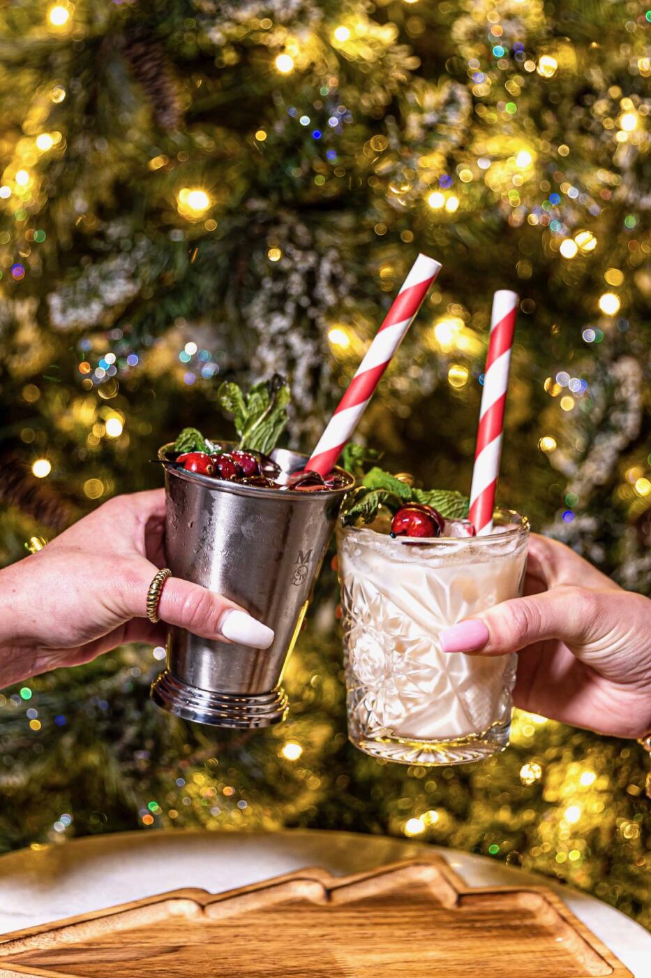 Customers clank their holiday cocktails together at Hubbard Inn with candy cane straws!