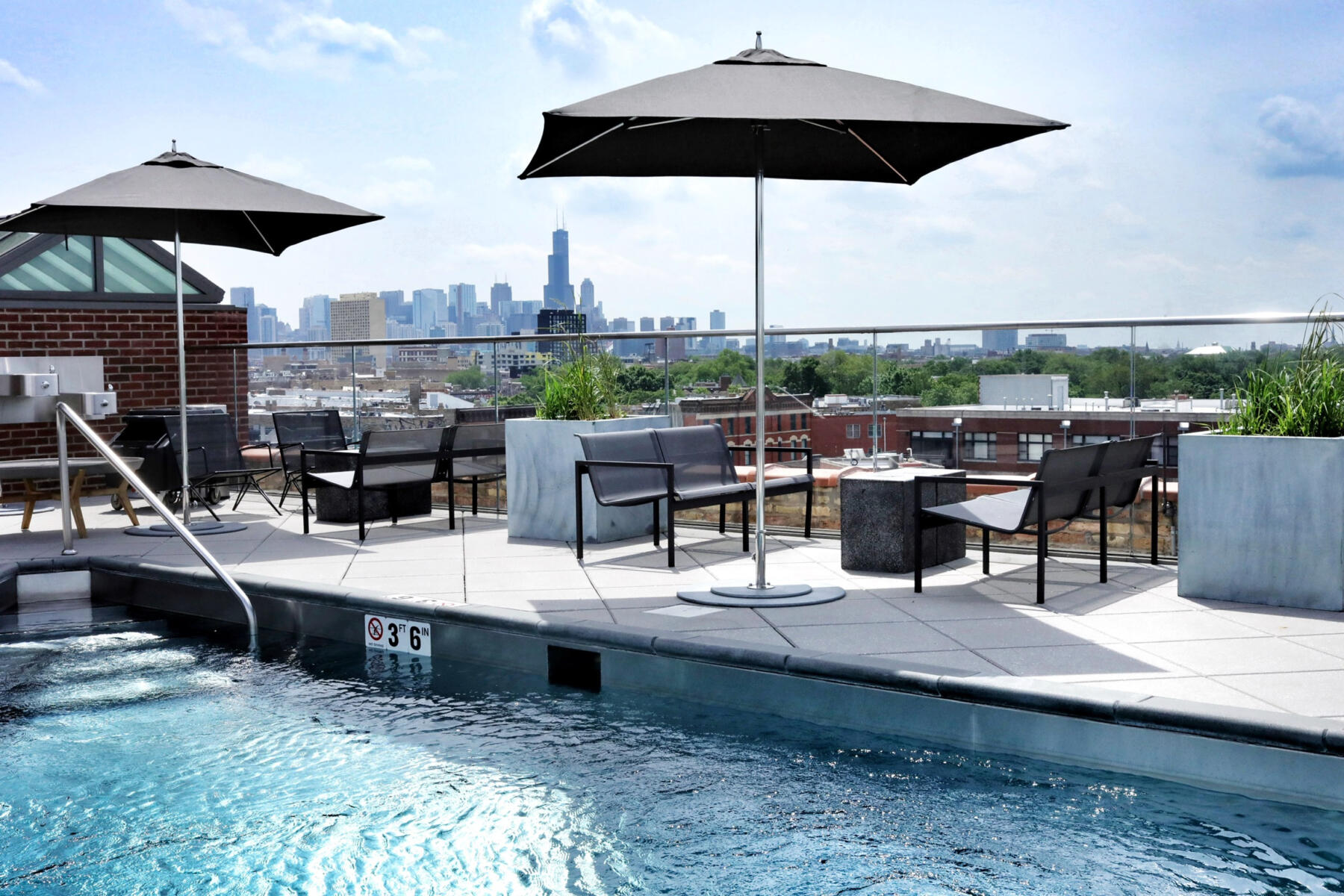 The rooftop bar with a pool and skyline views at The Robey