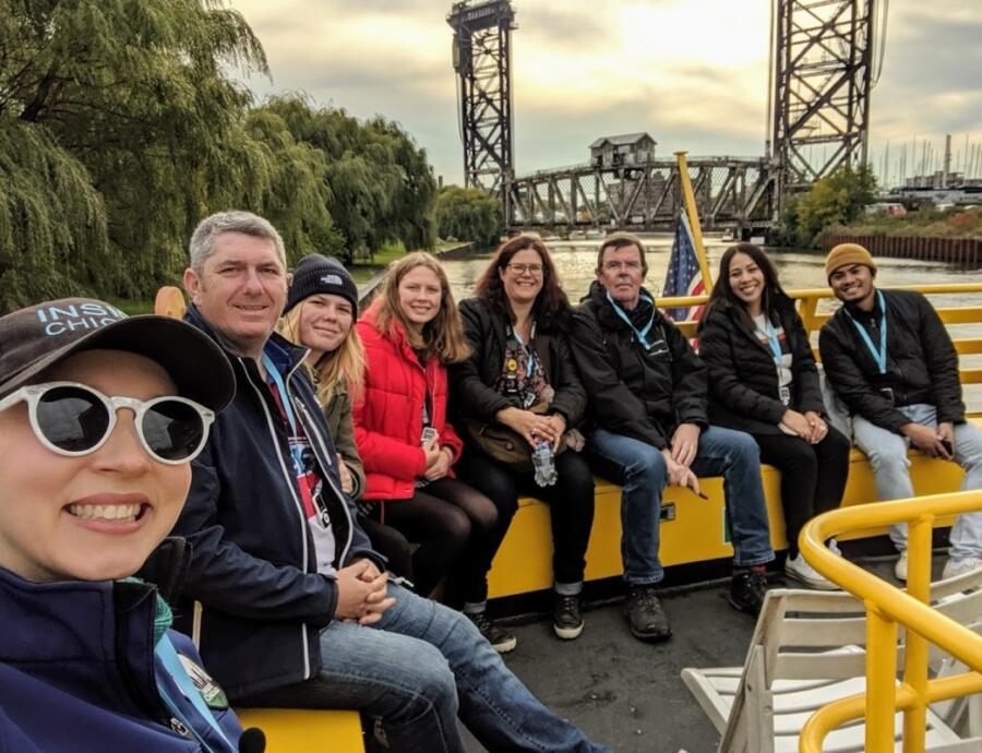 People sit inside a boat in the Chicago River taking part in an excursion with Inside Chicago Walking Tours