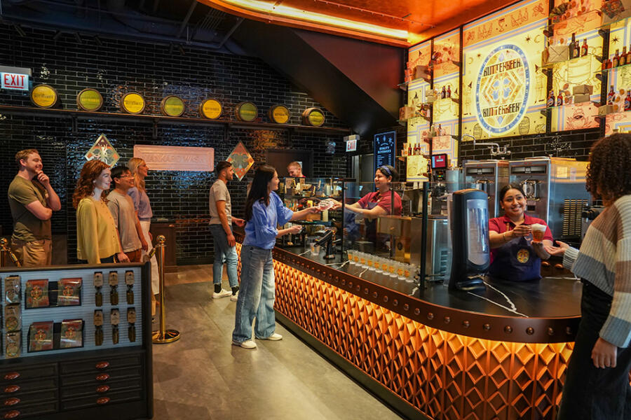 Patrons at the Butterbeer Bar inside the Harry Potter Shop
