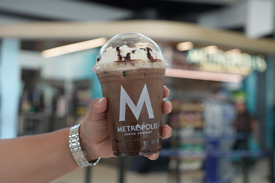 A frozen chocolate coffee being handed off at the Metropolis Coffee Company shop