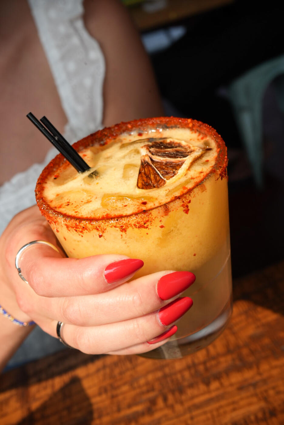 A person holds a cocktail at Irazu Costa RIcan in Bucktown