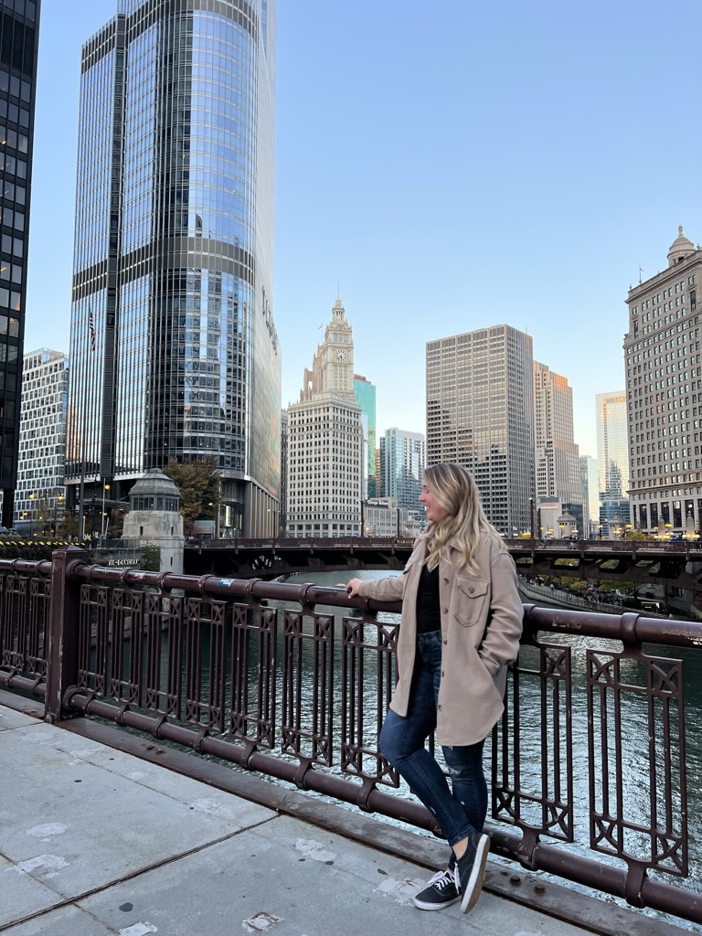 A young woman on a bridge over the Chicago River