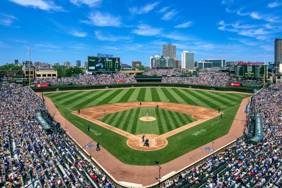 Players on the field and fans in the stands at a Chicago Cubs game at Wrigley Field