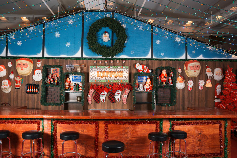 Happy's Chicago bar decorated with holiday stockings, Christmas wreath, Santa signs, and more Christmas decorations