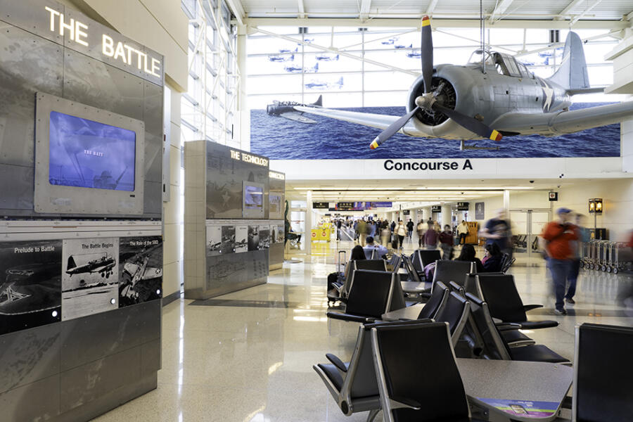 Battle of the Midway Memorial exhibit at Chicago Midway International Airport exhibit includes an aircraft hanging from the ceiling in Concourse A Hall