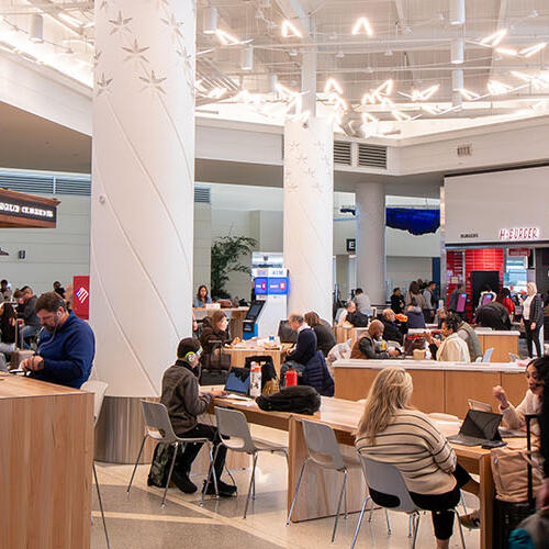 Travelers rlelax. work and eat before and after flights at Midway Central Market