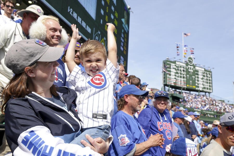 Fans cheer for the Chicago Cubs in the bleachers at Wrigley Field.